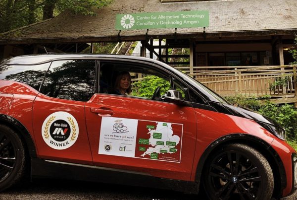 Lucy rigley in a red bmw i3 outside the Centre for Alternative Technology in wales